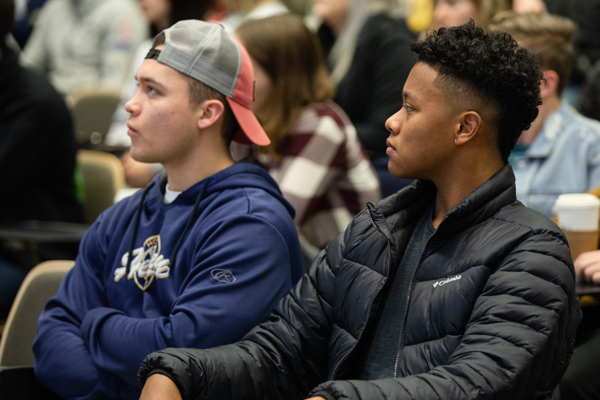 Two College of Business students listening in class