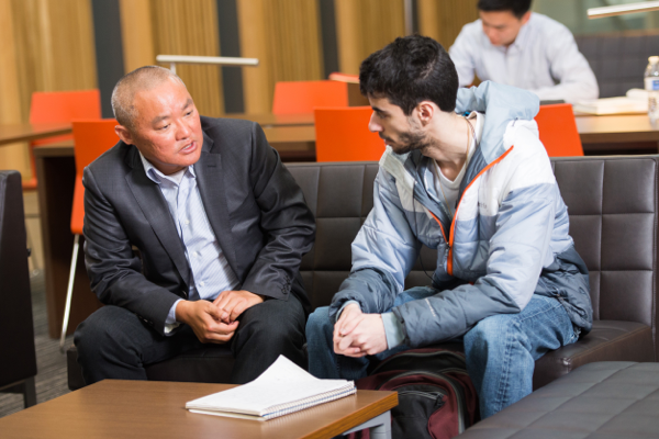 A College of Business faculty member meets with a student in Austin Hall